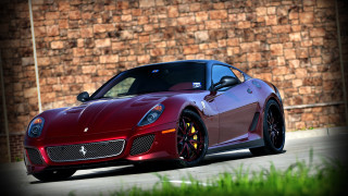 Red sports car brick wall - grass in front free wallpaper