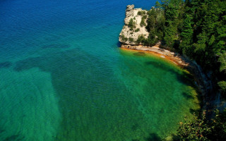 Water rock shoreline trees bush - both side free wallpaper
