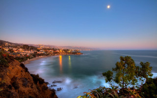 City ocean cliff moon scene - free sunset wallpaper