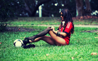 Woman sitting grass soccer phone - her hand and a cell phone free wallpaper