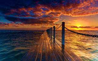 Sunset dock clouds water cityscape - a dock free wallpaper