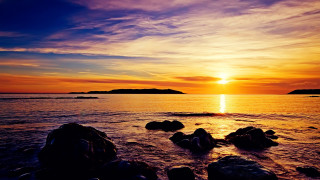 Sunset water rocks island matte - a small island in the distance free wallpaper