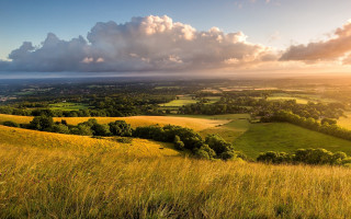 Grassy field valley clouds trees - a view of a valley free wallpaper