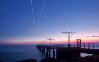 Pier plane sunset contrails water 2 - almada negreiro free wallpaper