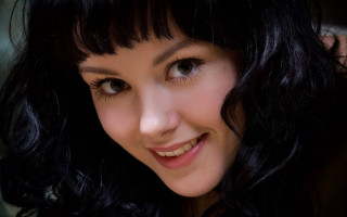 Woman black hair smiling portrait - shaded free wallpaper