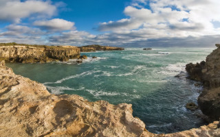 Rocky cliff ocean cloudy day - wide angle len free wallpaper