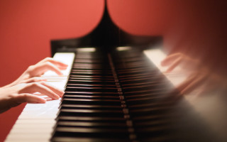 Hands playing piano red black - a piano keyboard free wallpaper