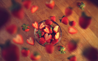 Strawberries wooden table scattered leaves - a bowl of strawberries free wallpaper