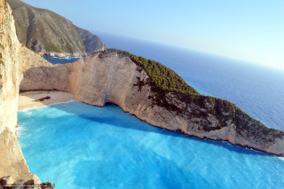 Large rock formation water cliff - a blue ocean free wallpaper for desktop