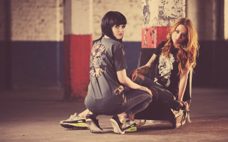 Two women skateboards fashion photorealistic - ed roth free wallpaper