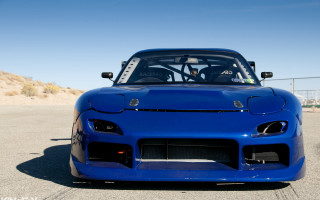 Blue sports car parking lot - a sky background and a person free wallpaper