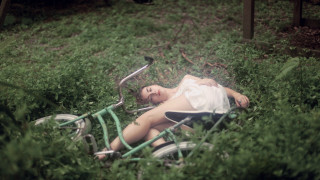 Woman bike grass overgrown nature - color film photography free wallpaper