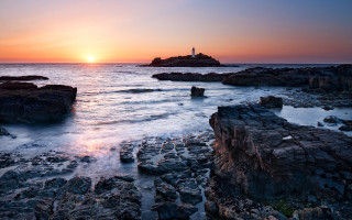 Lighthouse rocky shore sunset water 2 - a rocky shore free wallpaper