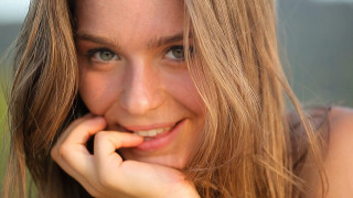 Woman longhair smiling cellphone portrait - her ear free wallpaper