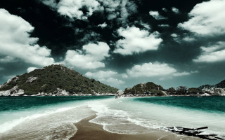 Beach mountain water cloudy sky 3 - a mountain in the background and a body of water free wallpaper