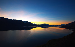 Lake mountains sunset city sky - orange glow free wallpaper