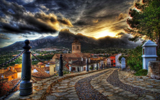 Cobblestone village clocktower mountains magic - a village free wallpaper