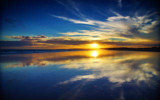 Sunset beach waves person reflecting - the beach in the distance free wallpaper
