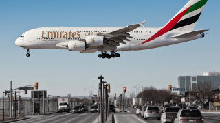 Emirates jetliner over busy street - busy free wallpaper