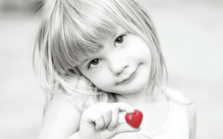 Little girl holding heart smiling - a little girl holding free wallpaper