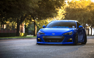 Blue sports car parked city - wide len free wallpaper