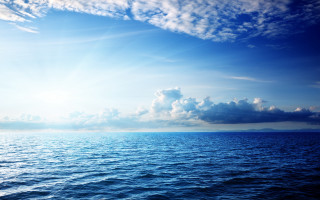 Ocean clouds boat sky mountain - the water below free wallpaper