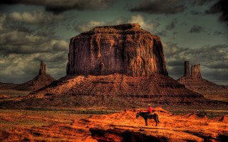 Desert horse mountain rock clouds - a large rock formation in the background free wallpaper