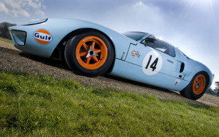 Blue racecar orange wheels road - a blue race car free wallpaper