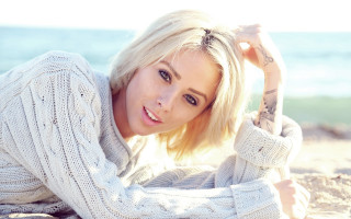 Woman beach blonde sweater blue - a blue ocean in the background free wallpaper