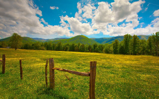 Fence mountains clouds green field 2 - in a field free wallpaper