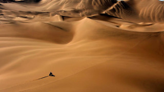 Lone person desert dune sunset - a few hill free wallpaper