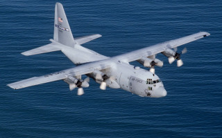 Large airplane over ocean landing - isometric view free wallpaper