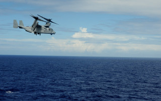 Helicopter ocean clouds boat dock - a boat in the background and a boat free wallpaper