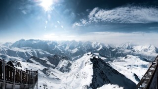 Mountain range snowy horizon sun - covered mountain free wallpaper