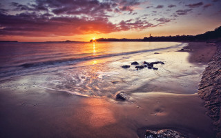 Sunset beach rocks clouds city - the water and a sky free wallpaper