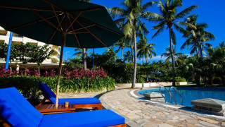Pool lounge umbrella stone walkway - a blue umbrella free wallpaper