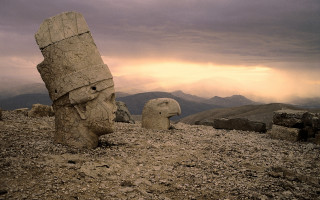 Rock face sculpture mountains cloudy - a rocky hillside free wallpaper