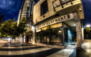Streetcorner building trees night artdeco - a building and trees free wallpaper
