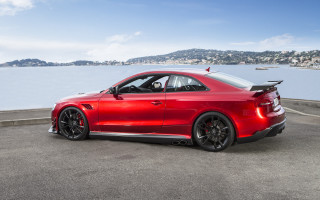 Red sports car mountain water - the side of a road near a body of water free wallpaper
