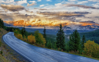Mountain road clouds trees sky - a mountain in the background free wallpaper