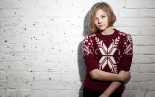 Woman red sweater white brick - short hair free wallpaper