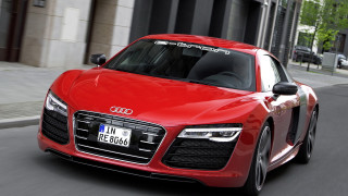 Red car driving tall building - redshift free wallpaper