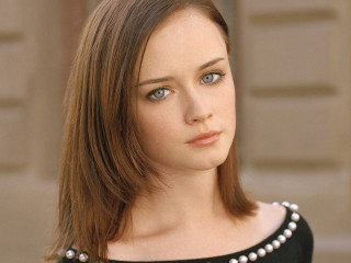 Woman pearl necklace black top - a door in the background free wallpaper