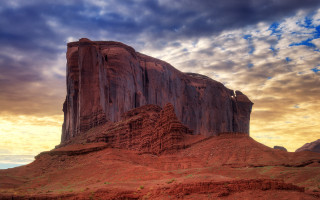 Desert rock formation cloudy sky 4 - a large rock formation in the middle of a desert area free wallpaper
