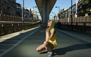 Woman yellow dress sitting urban - a street corner free wallpaper