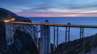 Train bridge ocean mountains dusk - a view of the ocean and mountains free wallpaper