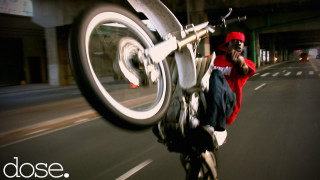 Man riding bike street building - a bike free wallpaper