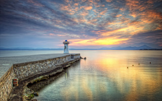 Lighthouse sunset pier clouds water - a pier free wallpaper