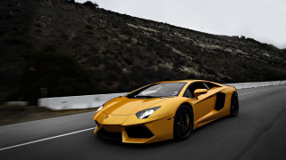 Yellow sports car driving mountain - foggy free wallpaper