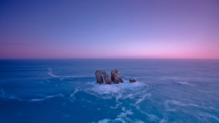 Rock formation ocean sunset pink 2 - a pink sky in the background free wallpaper